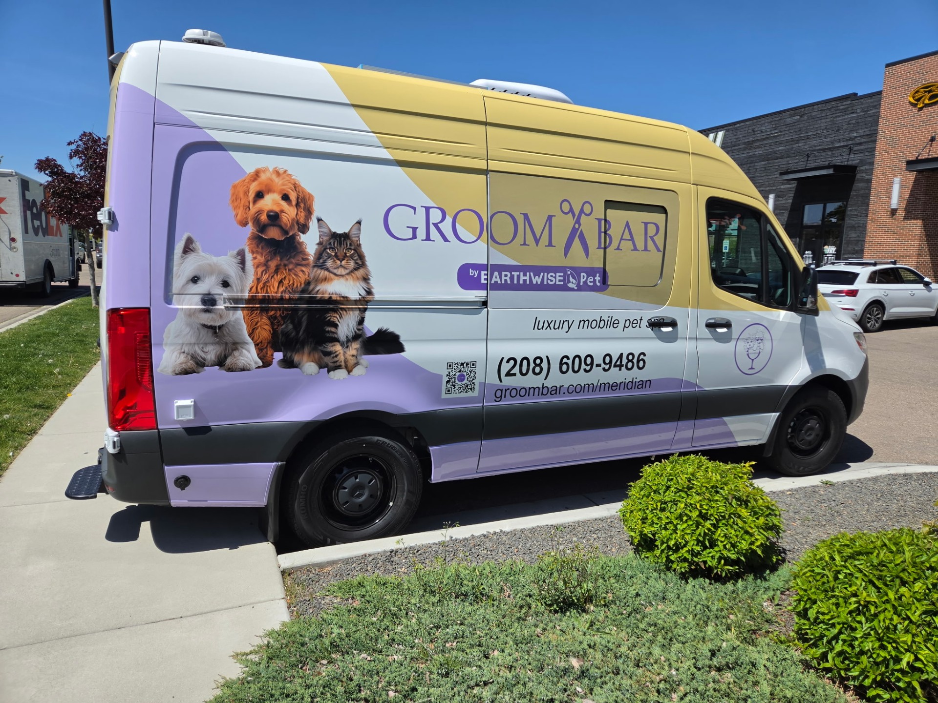 Groombar Meridian luxury mobile pet spa Sprinter van parked curbside with purple and yellow wave wrap
